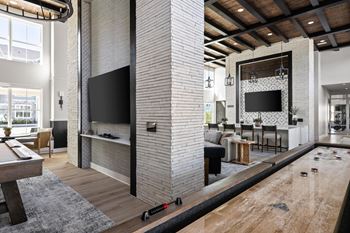 A room with a pool table and a television.